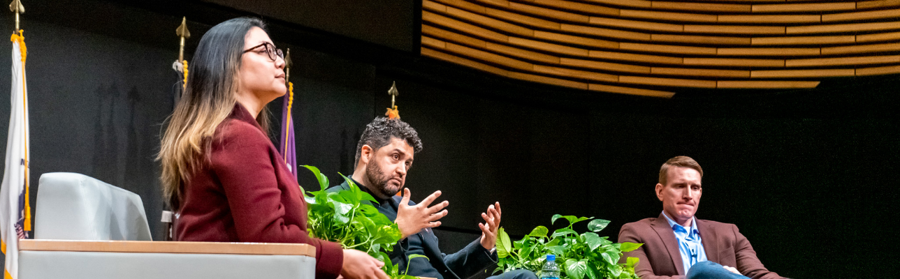 Three people at a forum